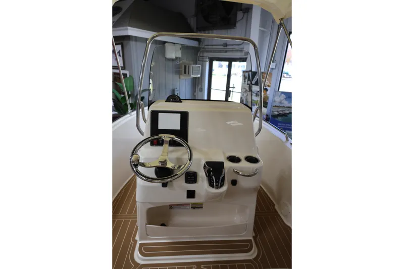 Slide: The Image of 2026 Grady-White Fisherman 180 boat interior at a boat show display. - 6