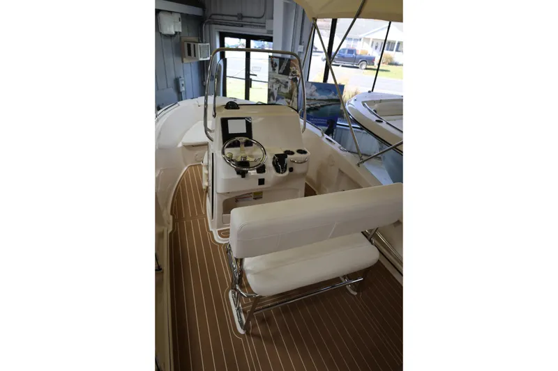 Slide: The Image of 2026 Grady-White Fisherman 180 boat interior with cushioned seating and storage compartment. - 7