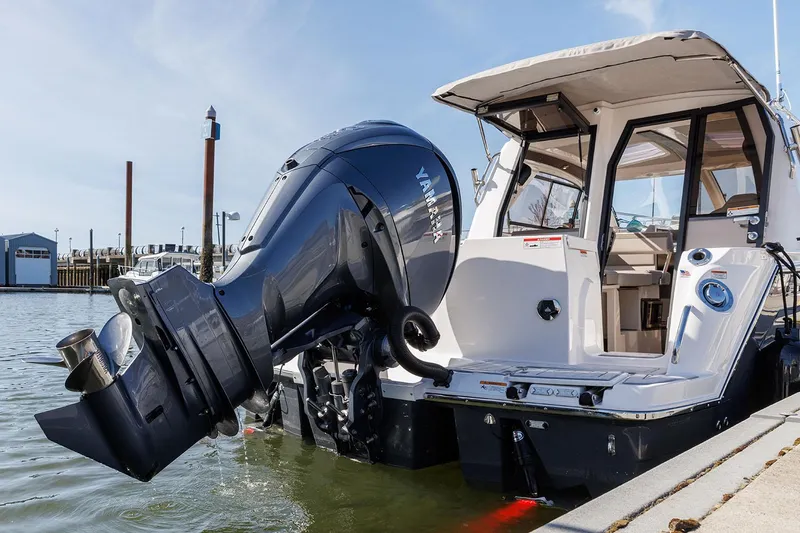 Slide: The Image of Manufacturer Provided Image: 2025 Solara S-250 Coupe boat with powerful outboard motor docked at marina. - 5