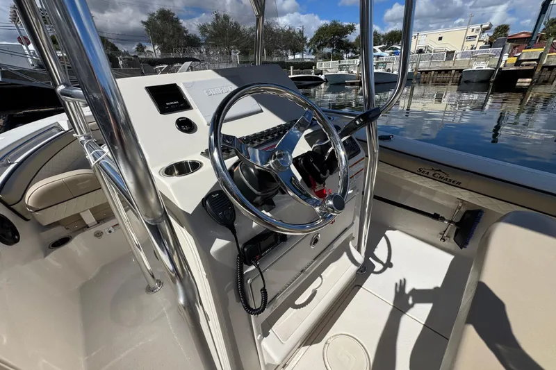 Slide: The Image of 2022 Sea Chaser 22 HFC boat interior with steering wheel and control panel. - 11