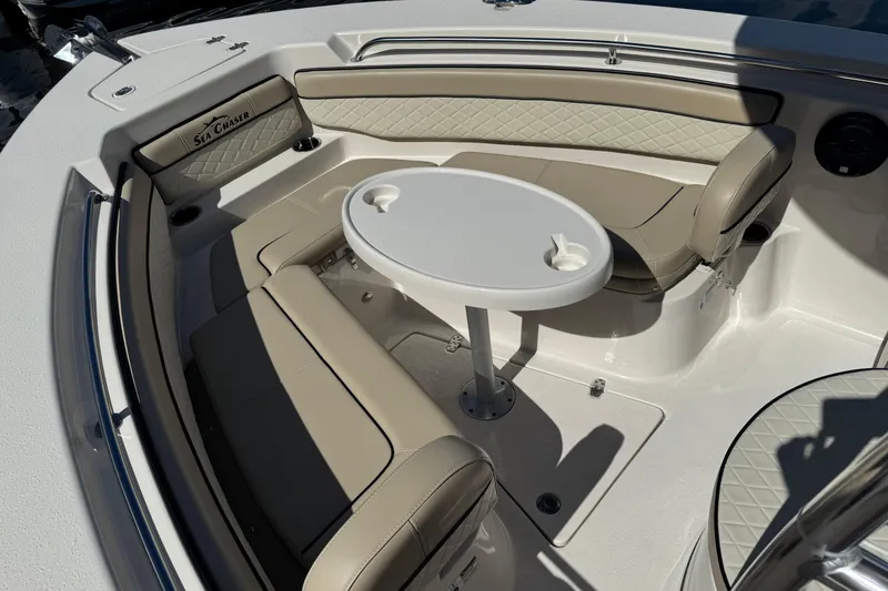 Slide: The Image of 2022 Sea Chaser 22 HFC boat interior with beige seating and a round table. - 15