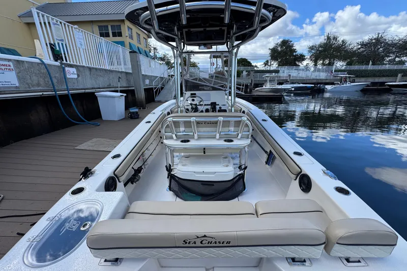Slide: The Image of 2022 Sea Chaser 22 HFC boat docked, showcasing spacious interior and sleek design. - 6