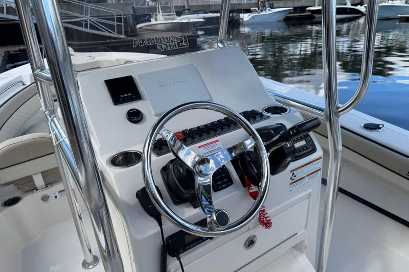 Slide: The Image of 2022 Sea Chaser 22 HFC boat console with steering wheel and controls. - 9