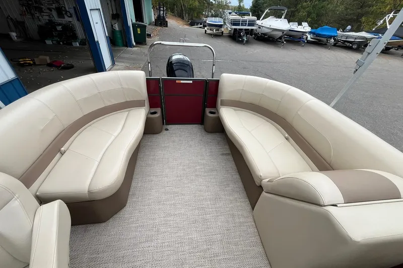 Slide: The Image of 2017 Crest I 220 L pontoon boat with beige seating, docked near other boats. - 11