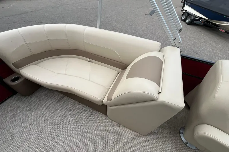 Slide: The Image of 2017 Crest I 220 L boat interior with beige seating and cup holder. - 12
