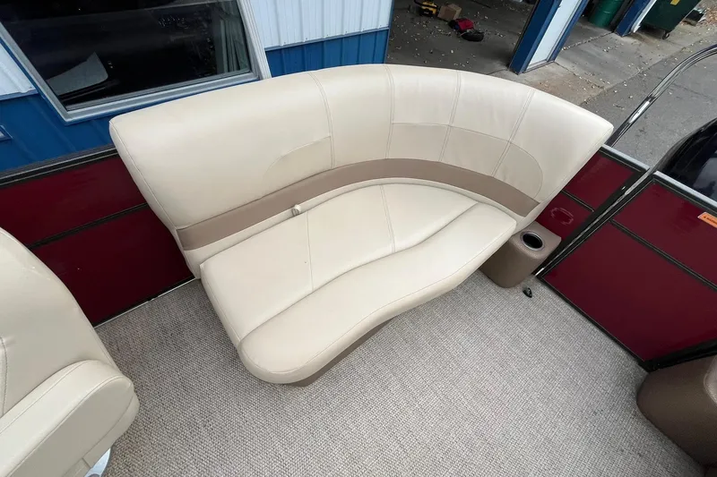 Slide: The Image of Beige seating on 2017 Crest I 220 L boat, featuring curved design and cup holder. - 13