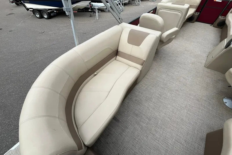 Slide: The Image of 2017 Crest I 220 L boat interior with beige seating and carpeted floor. - 17