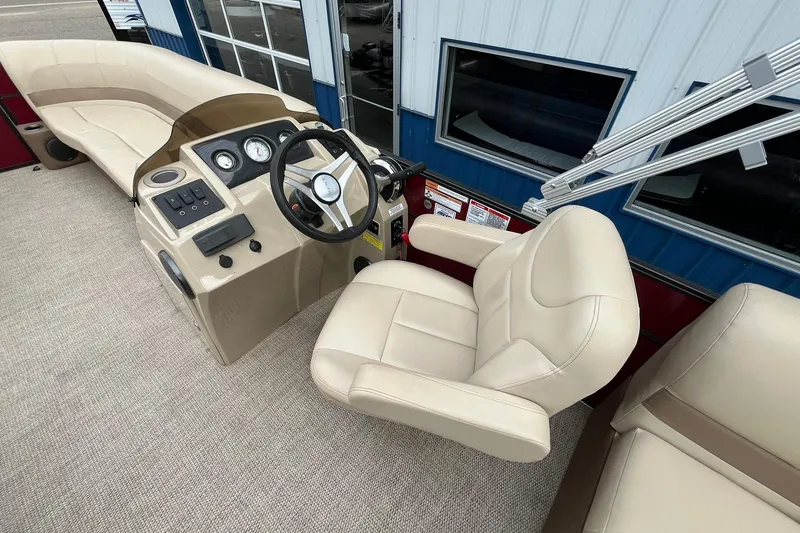 Slide: The Image of 2017 Crest I 220 L boat interior with beige seating and control panel. - 19