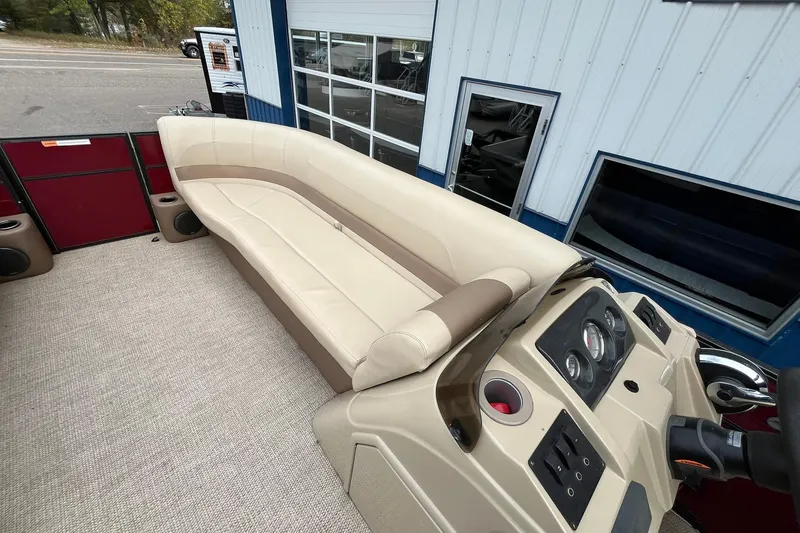 Slide: The Image of 2017 Crest I 220 L boat interior with beige seating and control panel. - 23