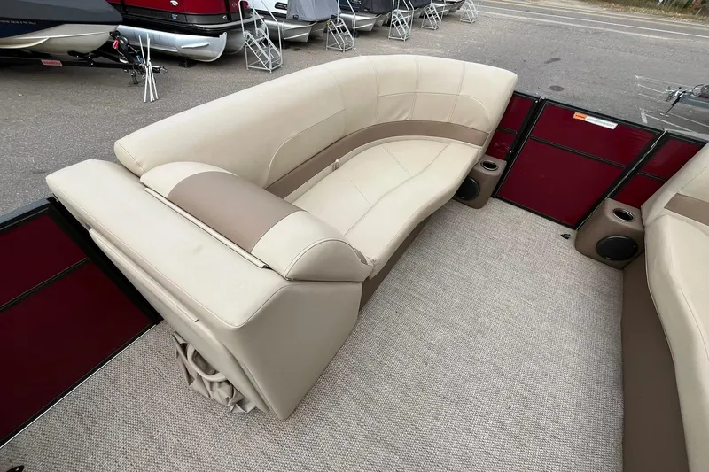 Slide: The Image of Luxurious seating on 2017 Crest I 220 L pontoon boat, featuring beige and brown upholstery. - 24