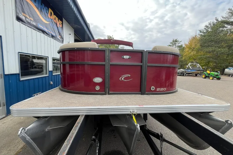 Slide: The Image of 2017 Crest I 220 L pontoon boat with red exterior, displayed outdoors. - 6