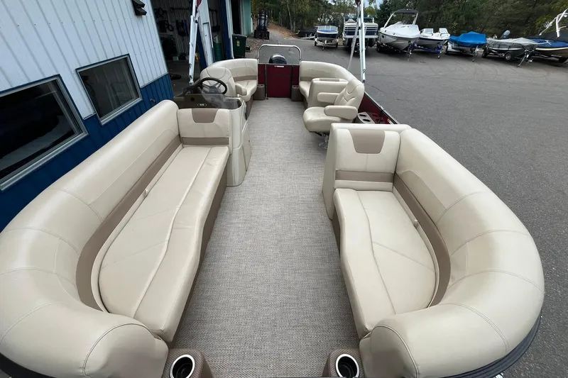 Slide: The Image of 2017 Crest I 220 L pontoon boat with beige seating and spacious interior layout. - 7