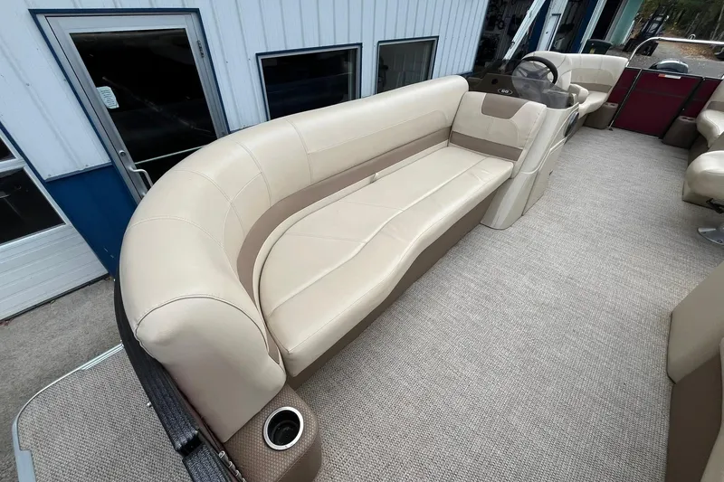 Slide: The Image of 2017 Crest I 220 L pontoon boat interior with beige seating and carpeted floor. - 8