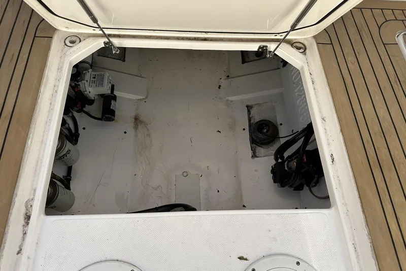 Slide: The Image of Open storage compartment of a 2016 Pursuit DC 325 Dual Console boat. - 10