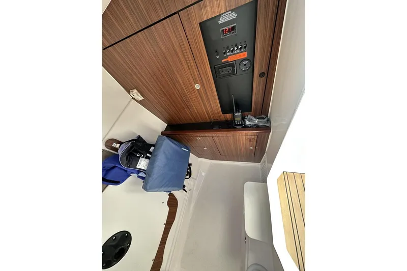 Slide: The Image of 2016 Pursuit DC 325 Dual Console interior with control panel and storage. - 21