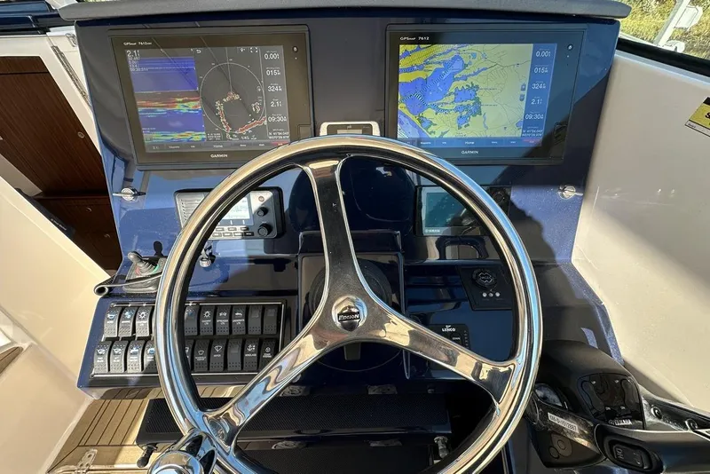 Slide: The Image of 2016 Pursuit DC 325 Dual Console helm with Garmin navigation displays and controls. - 24