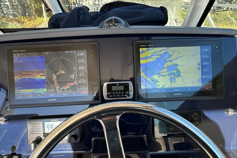 Slide: The Image of Helm of 2016 Pursuit DC 325 Dual Console with Garmin navigation displays. - 25