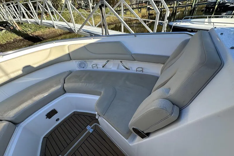 Slide: The Image of 2016 Pursuit DC 325 Dual Console boat interior with cushioned seating and wooden flooring. - 29