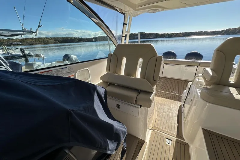Slide: The Image of 2016 Pursuit DC 325 Dual Console boat interior with lake view and seating. - 34