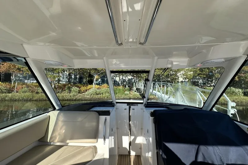 Slide: The Image of Interior view of 2016 Pursuit DC 325 Dual Console boat with seating and windows. - 37