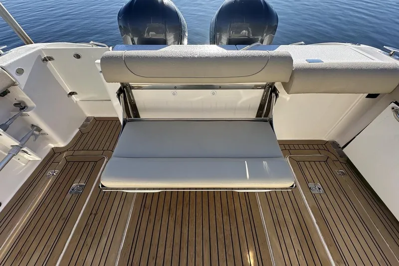 Slide: The Image of 2016 Pursuit DC 325 Dual Console boat with foldable seat and teak flooring. - 9