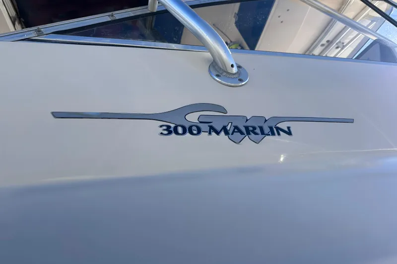 Slide: The Image of 2007 Grady-White Marlin 300 boat logo on white surface. - 11