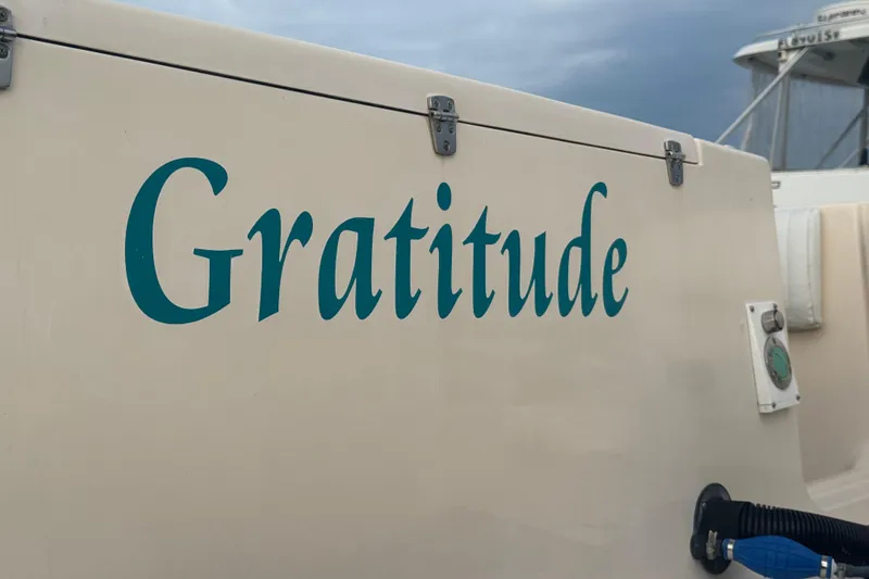 Slide: The Image of 2007 Grady-White Marlin 300 boat with "Gratitude" name on the side. - 18