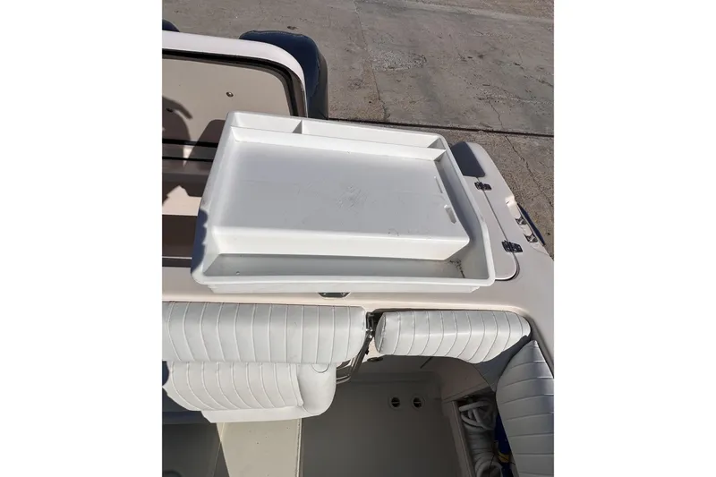 Slide: The Image of 2007 Grady-White Marlin 300 boat with white seating and a storage compartment. - 26