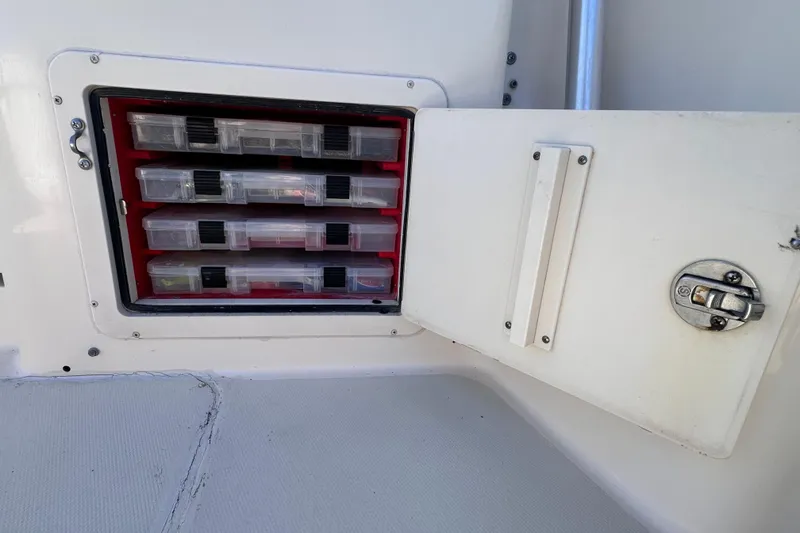 Slide: The Image of Storage compartment with tackle boxes on a 2007 Grady-White Marlin 300 boat. - 35