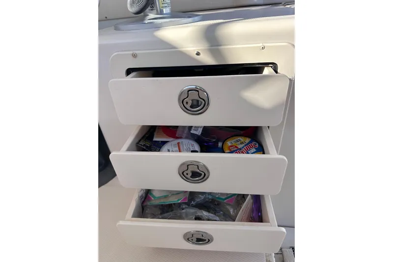 Slide: The Image of Open storage drawers on a 2007 Grady-White Marlin 300 boat, containing various items. - 36