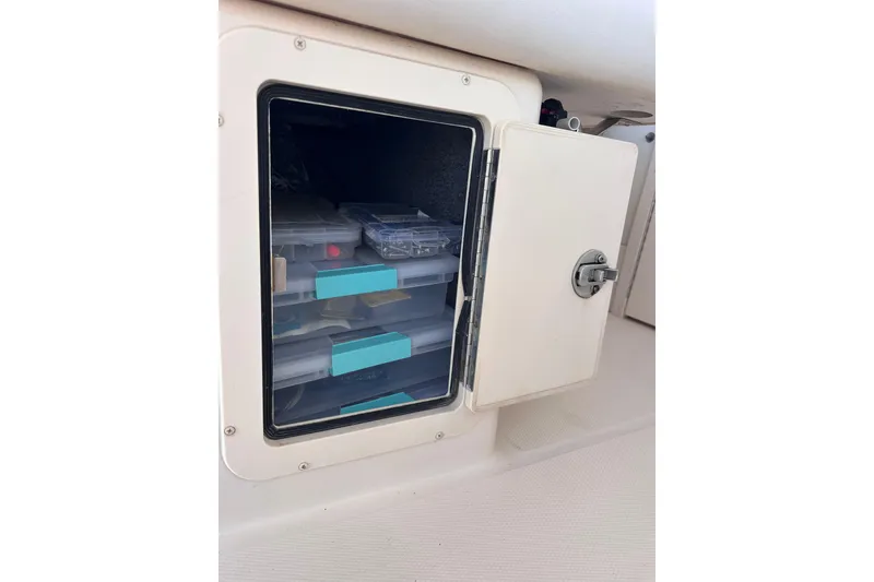 Slide: The Image of Storage compartment on a 2007 Grady-White Marlin 300 boat with organized tackle boxes. - 37