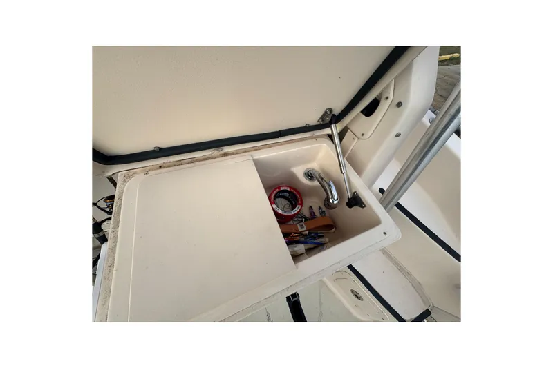 Slide: The Image of 2007 Grady-White Marlin 300 boat sink with storage compartment and faucet. - 39