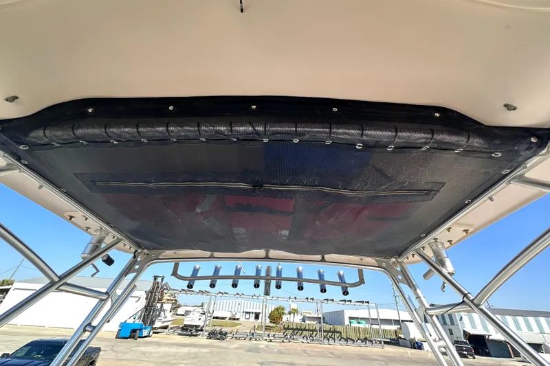 Slide: The Image of 2007 Grady-White Marlin 300 boat canopy and rod holders, dockside view. - 46