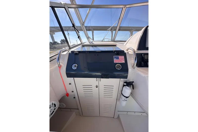 Slide: The Image of 2007 Grady-White Marlin 300 helm with American flag sticker and fire extinguisher. - 48