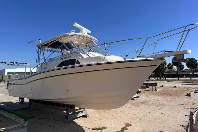 Slide: The Image of 2007 Grady-White Marlin 300 boat on dry dock under clear blue sky. - 5