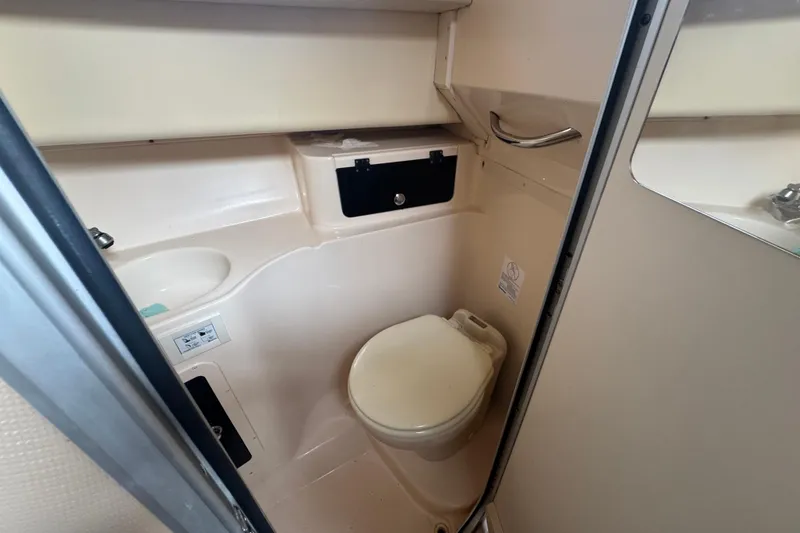 Slide: The Image of 2007 Grady-White Marlin 300 boat bathroom interior with toilet and sink. - 50