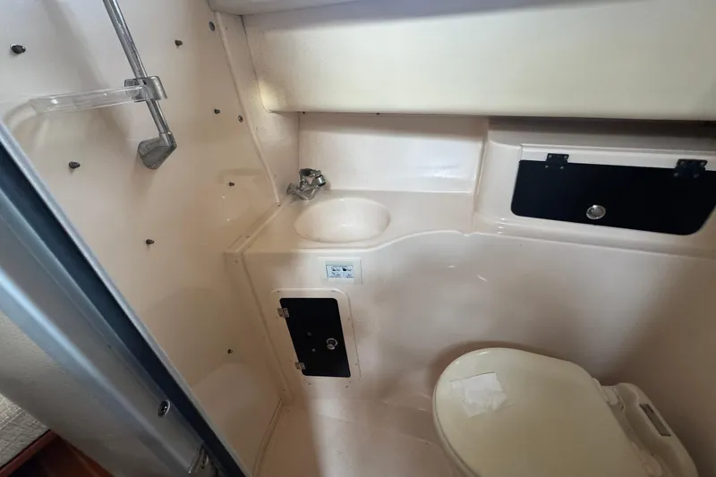 Slide: The Image of 2007 Grady-White Marlin 300 boat bathroom with shower, sink, and toilet. - 51