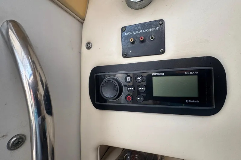 Slide: The Image of Audio system controls on a 2007 Grady-White Marlin 300 boat dashboard. - 56