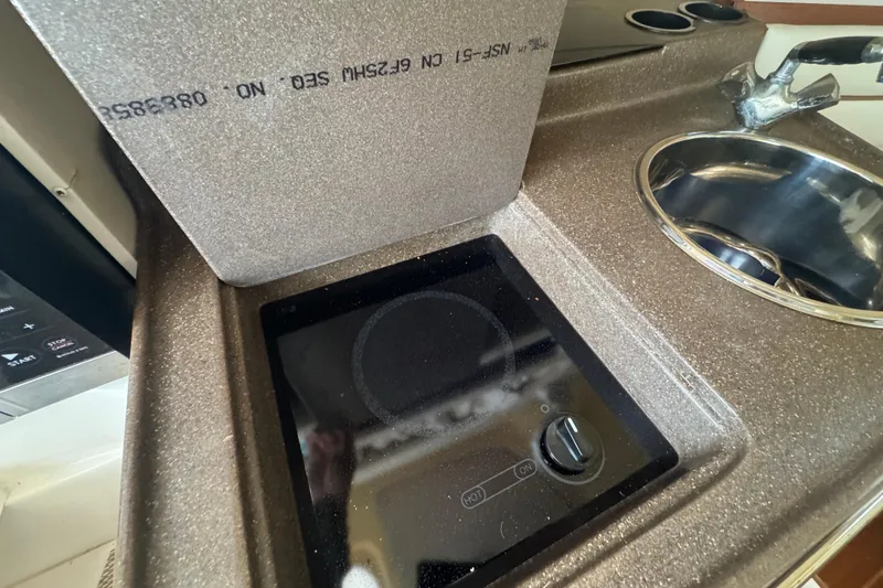 Slide: The Image of 2007 Grady-White Marlin 300 boat kitchen with stove and sink. - 58