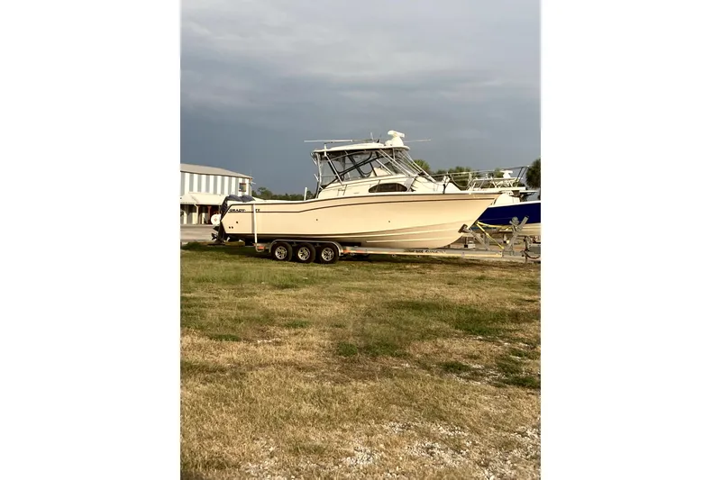 Slide: The Image of 2007 Grady-White Marlin 300 boat on trailer, parked on grassy area. - 59