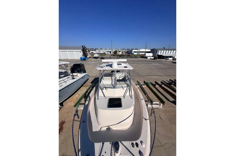 Slide: The Image of 2007 Grady-White Marlin 300 boat docked in a marina under clear blue skies. - 8