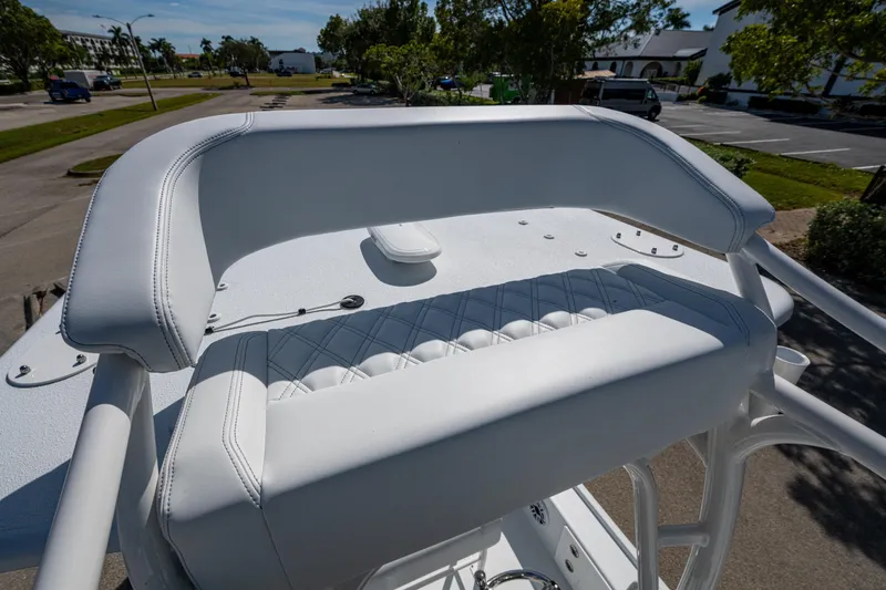 Slide: The Image of 2026 Yellowfin 24 Bay CE boat with white cushioned seating and sleek design. - 10