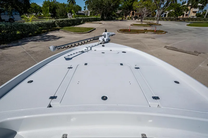 Slide: The Image of 2026 Yellowfin 24 Bay CE boat deck with trolling motor in a parking area. - 11