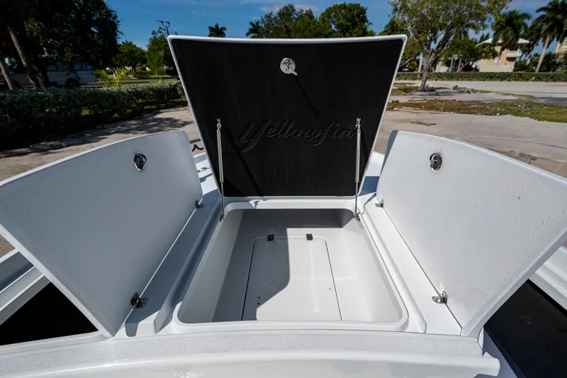 Slide: The Image of Open storage compartments on a 2026 Yellowfin 24 Bay CE boat. - 13