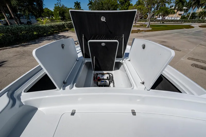 Slide: The Image of 2026 Yellowfin 24 Bay CE boat storage compartments open, showcasing interior space. - 14
