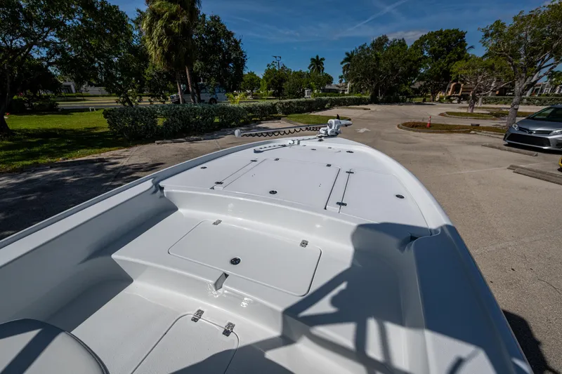 Slide: The Image of 2026 Yellowfin 24 Bay CE boat deck in a sunny outdoor setting. - 18