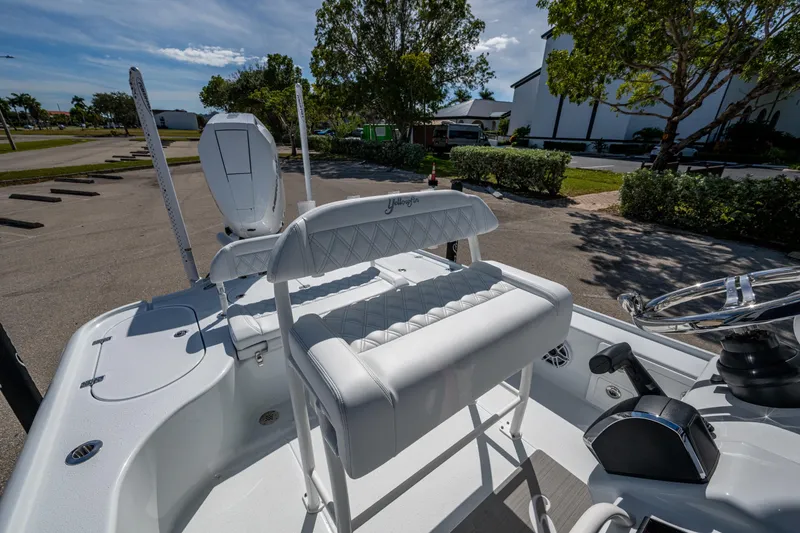 Slide: The Image of 2026 Yellowfin 24 Bay CE boat interior with white seating and steering wheel. - 19