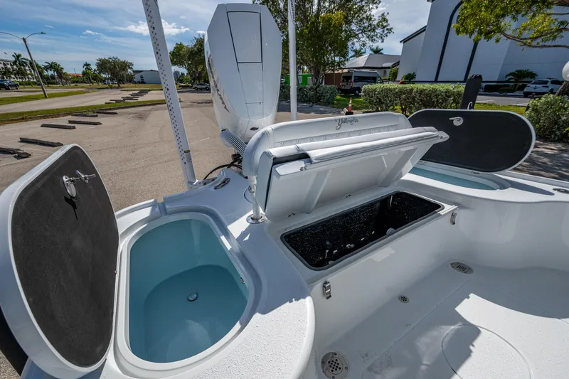 Slide: The Image of 2026 Yellowfin 24 Bay CE boat with open storage compartments and sleek design. - 21