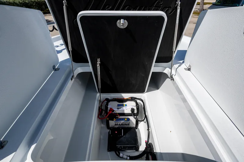 Slide: The Image of 2026 Yellowfin 24 Bay CE boat storage compartment with marine battery and wiring. - 23
