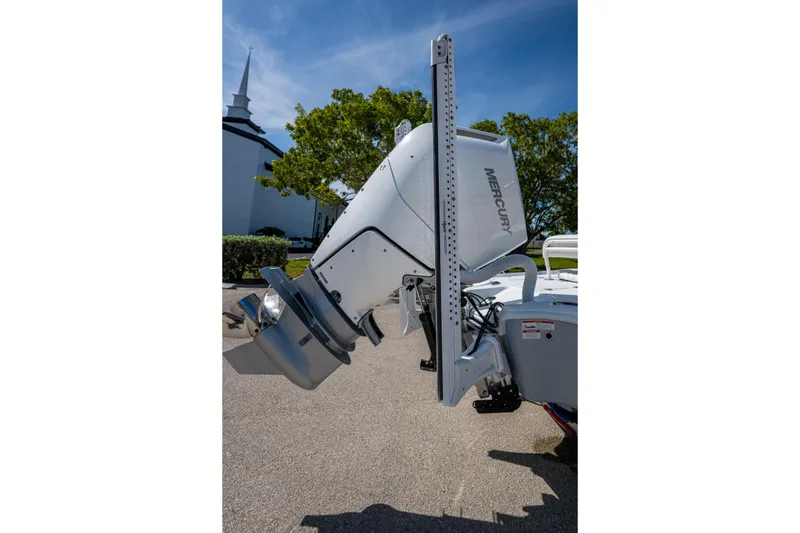 Slide: The Image of 2026 Yellowfin 24 Bay CE boat with Mercury outboard motor, parked outdoors. - 25